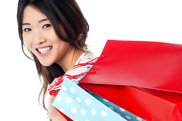 Image showing Cheerful young shopaholic girl