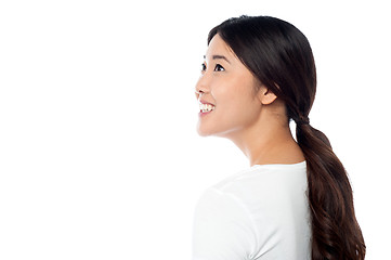 Image showing Smiling attractive girl looking at something