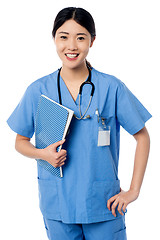 Image showing Female doctor holding patients records