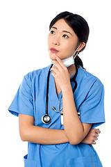 Image showing Female surgeon thinking something