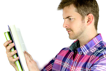 Image showing Thoughtful young man reading a book