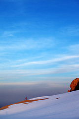 Image showing Hiker in sunrise snow mountains