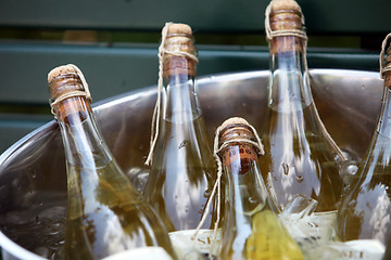 Image showing Champagne cooling in an ice bucket