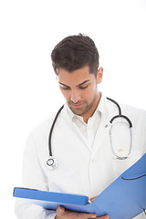 Image showing Male doctor reading a patients records