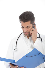 Image showing Young male doctor talking on a mobile phone