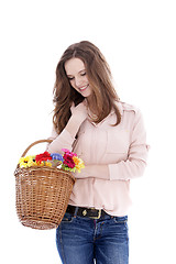 Image showing Smiling teenager with a basket of flowers