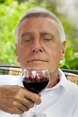 Image showing Happy senior enjoying drink