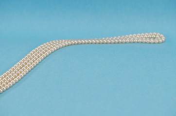 Image showing pearl necklace collar curve close blue background 