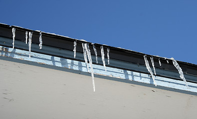 Image showing Bright winter day, icicles on the roof