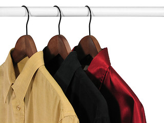 Image showing Colorful shirts on hangers, on white background