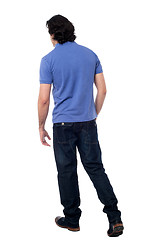 Image showing Casual young guy walking in studio