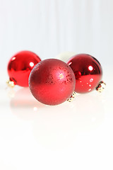 Image showing Three red Christmas baubles