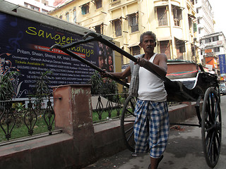 Image showing Men wait for passengers on their rickshaw