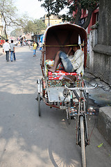 Image showing Men wait for passengers on their rickshaw