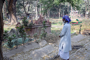 Image showing Man prays in front of the grave on Muslim cemetery in Kolkata