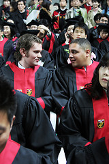 Image showing International graduates at an Asian university chat during a gra