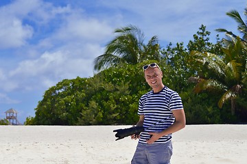 Image showing photographer taking photo on beach