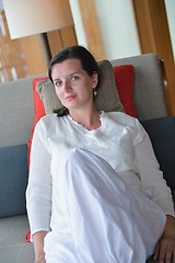 Image showing happy young woman relax at home on sofa