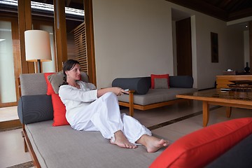 Image showing happy young woman relax at home on sofa