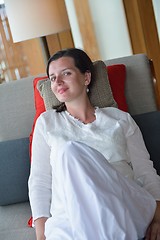 Image showing happy young woman relax at home on sofa