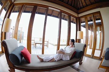 Image showing happy young woman relax at home on sofa