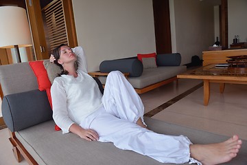 Image showing happy young woman relax at home on sofa
