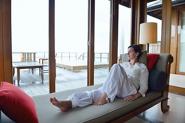 Image showing happy young woman relax at home on sofa