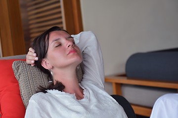 Image showing happy young woman relax at home on sofa