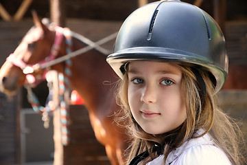 Image showing Little girl and brown Horse