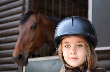 Image showing Little girl and brown Horse