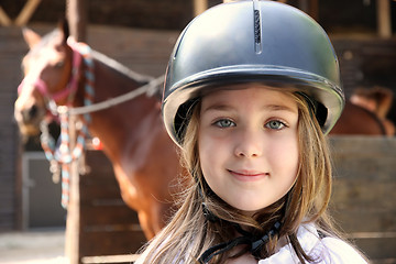 Image showing Little girl and brown Horse