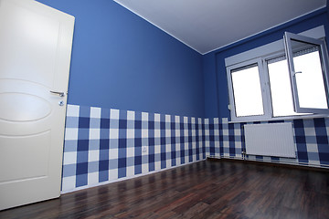 Image showing empty room with a blue wall and blue-white wallpaper 