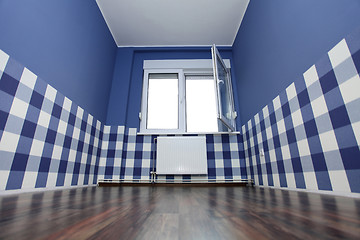 Image showing empty room with a blue wall and blue-white wallpaper 