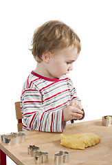 Image showing child baking cookies isolated on white background