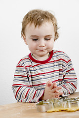 Image showing child child looking at backing utensil