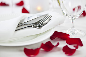 Image showing Romantic dinner setting with rose petals