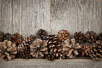 Image showing Rustic wood with pine cones