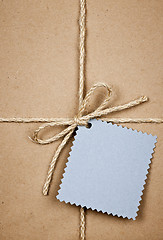 Image showing Gift with blue card in brown paper