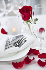 Image showing Romantic dinner setting with rose petals