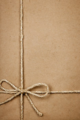 Image showing Package in brown paper tied with string