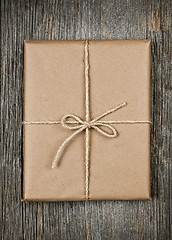 Image showing Gift in brown paper tied with string