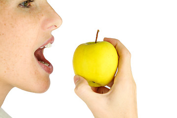 Image showing Girl taking a bite of an apple.