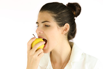 Image showing Girl taking a bite of an apple.