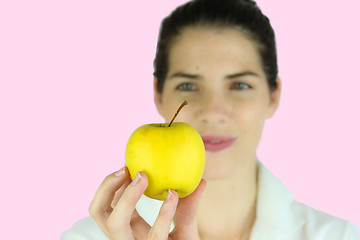 Image showing Girl holding a yellow apple