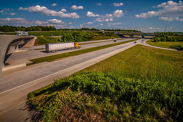 Image showing clover leaf exit ramps on highway near city