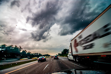 Image showing dramtatic sky and clouds with some rain while driving on a highw