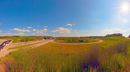 Image showing clover leaf exit ramps on highway near city