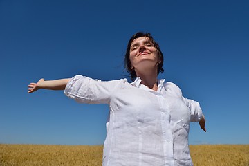 Image showing young woman with spreading arms to sky