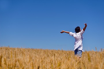 Image showing young woman in wheat field at summer