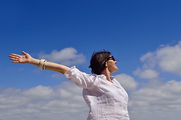 Image showing young woman with spreading arms to sky